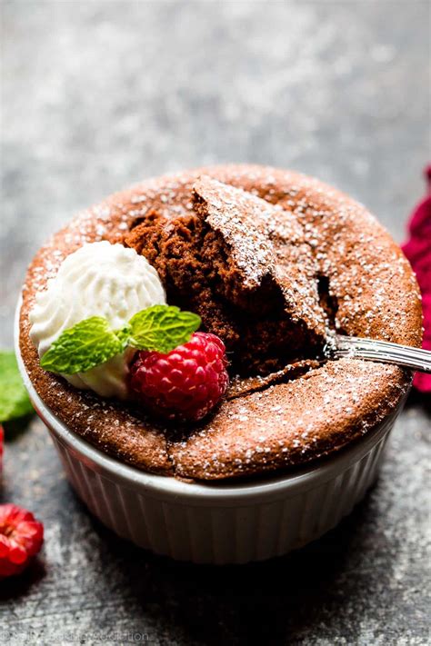 Thematic photo of chocolate soufflé on a plate with whipped cream