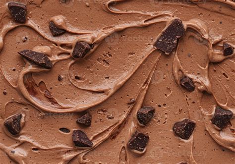 Close-up photo of rich chocolate cream being mixed with crushed cookies.