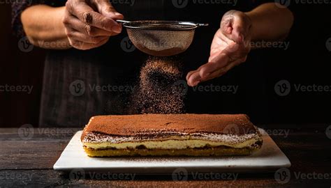 Plate of classic tiramisu with cocoa powder dusting.