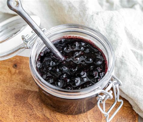 Sveže napolnjeni kozarci slivove marmelade, pokriti z brisačo