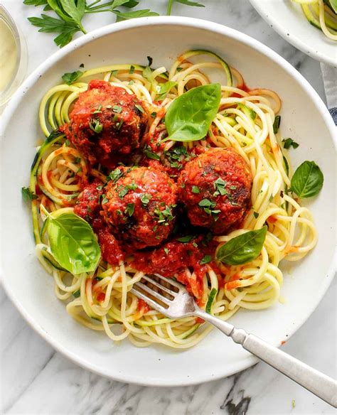 Thematic photo of a served dish of meatballs with pasta and sauce.