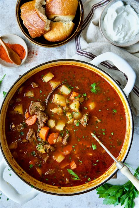 Thematic photo of veal goulash with mushrooms, served with side dish