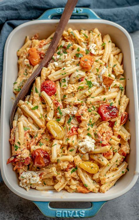 Baked feta cheese and cherry tomato sauce mixed with pasta and spinach.
