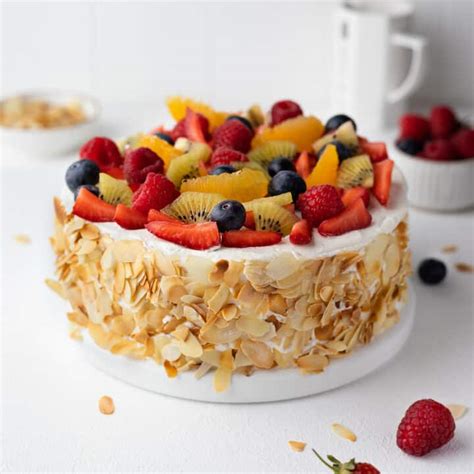 Colorful photo of a cake decorated with fresh berries and fruit