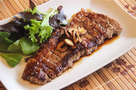 Thematic photo of beef steaks in sauce with side dish