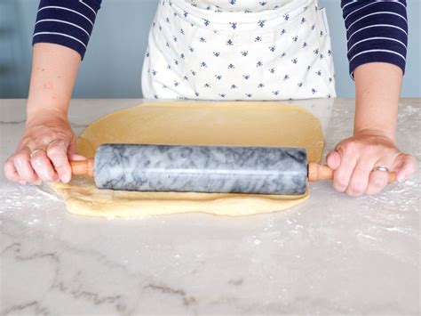 Photo of a rolled-out potica dough with filling spread on it, ready for rolling.