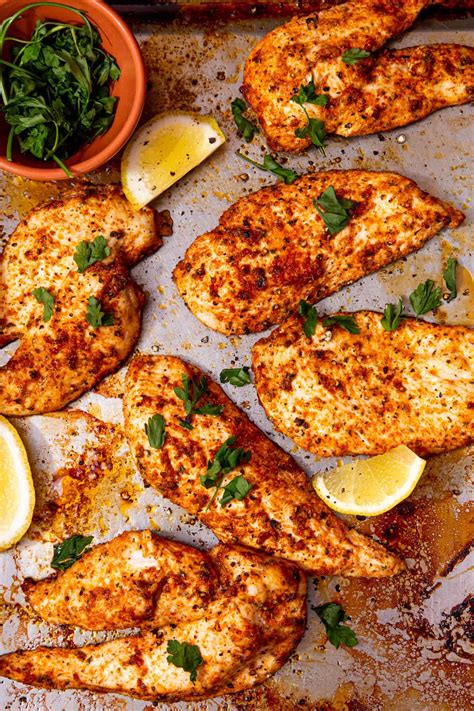 Thematic photo of cooked chicken fillet with olive oil and fresh herbs