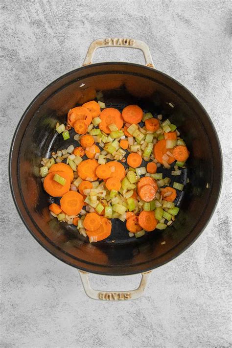 Thematic photo of grated carrots being sauteed in a pot