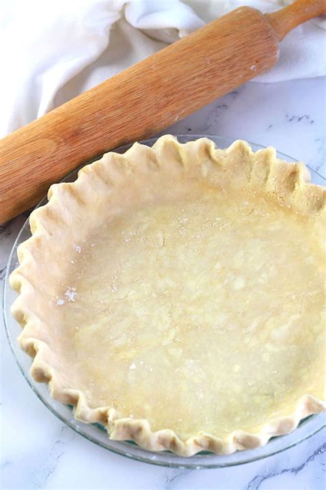 Themastic photo of a plate with dough, butter, flour, and sugar for a pie