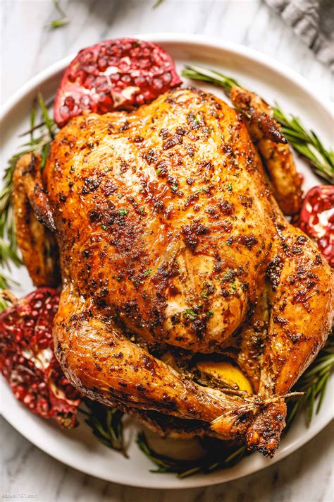Full shot of a whole roasted chicken in foil with herbs and garlic