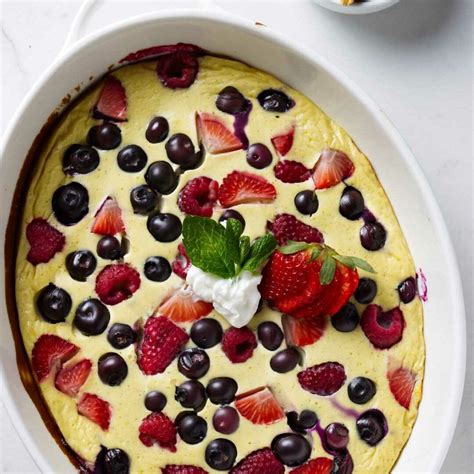 A beautifully baked yogurt cake with berries on top, ready to be served