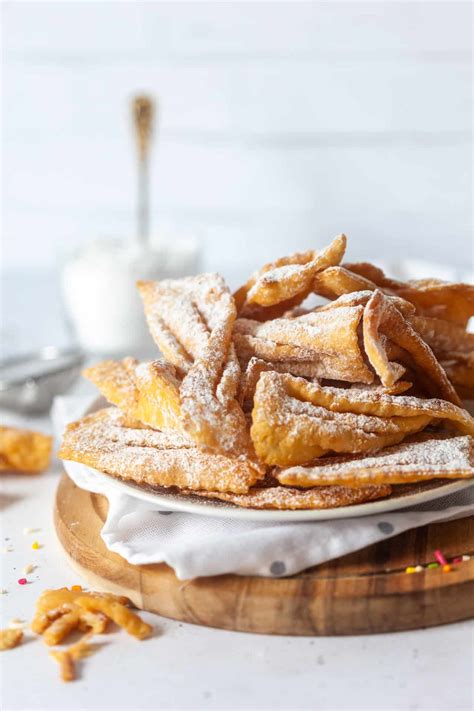 Thematic photo of freshly fried, sugar-dusted flancati on a plate
