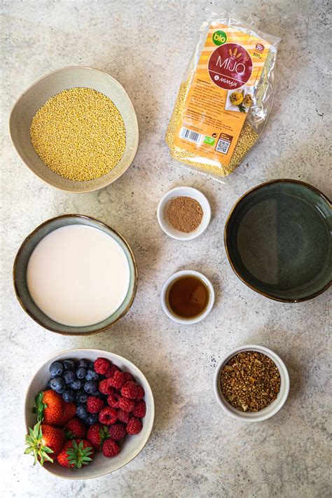 Ingredients for baked millet porridge with fruit arranged on a wooden table