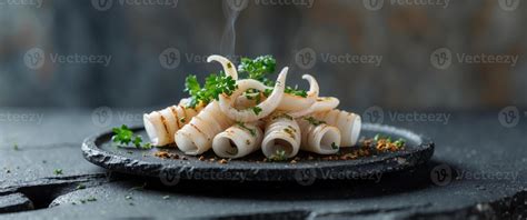 Thematic photo of fresh squid on a plate with herbs