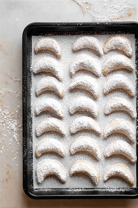 Photo of small crescent-shaped cookies (rogljički), perhaps dusted with powdered sugar.