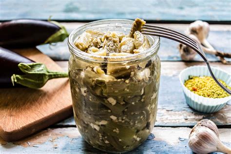 Jar of pickled eggplants in oil with herbs