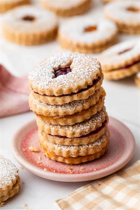 Thematic photo of Linzer cookies, stack of cookies with jam in between, decorated with powdered sugar, Christmas atmosphere