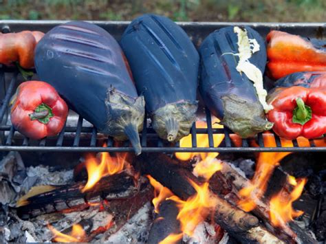Photo of roasting peppers and eggplants on a grill