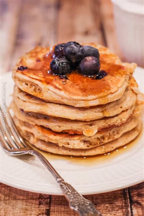 Thematic photo of fluffy oat protein pancakes on a plate with toppings