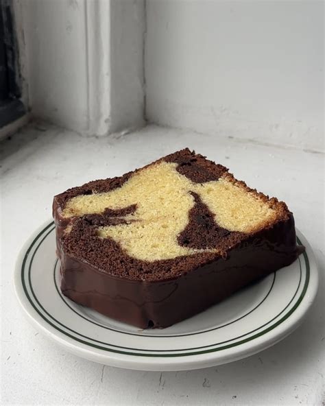 Thematic photo of a baked marble cake slice on a plate, showing the swirled pattern