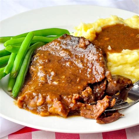 Thematic photo of a delicious stewed beef steak with sauce