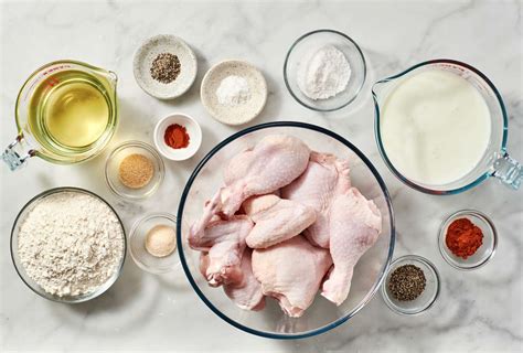 A table with all the ingredients for fried chicken