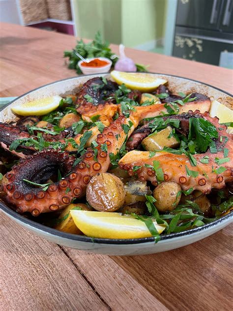 Thematic photo of a delicious baked octopus with potatoes and vegetables