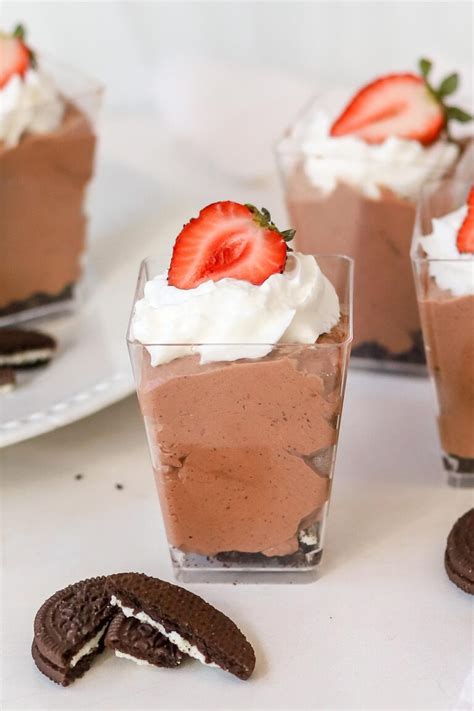 A smooth chocolate avocado mousse served in small dessert cups, garnished with fresh berries.