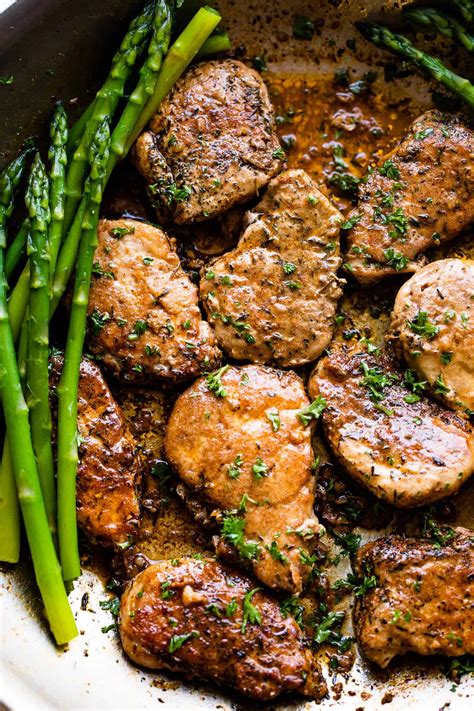 Thematic photo of cooked pork medallions with green asparagus