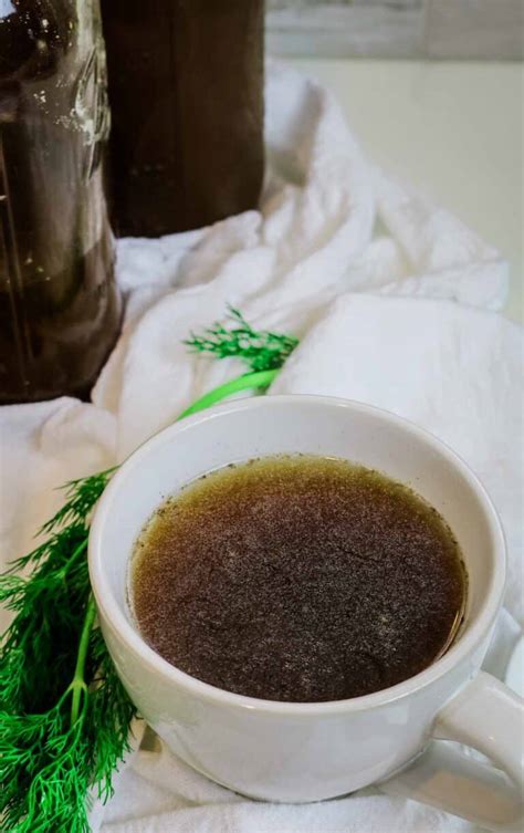 Photo of richly colored beef bone broth in a mug