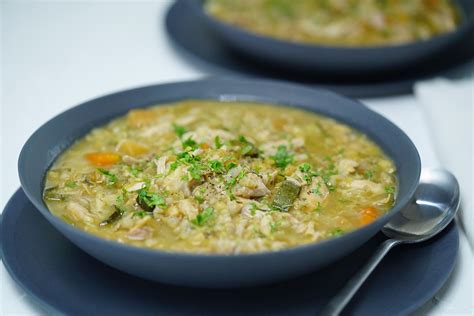 Photo of a hearty winter chicken soup with mixed vegetables