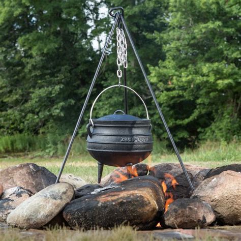 Thematic photo of a cast iron kettle over an open fire, cooking bograč.
