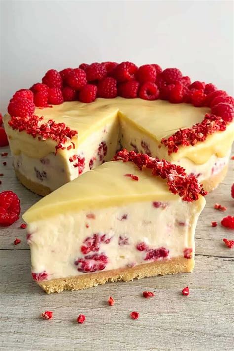 Thematic photo of a no-bake cheesecake slice with white chocolate and possibly passion fruit/berries