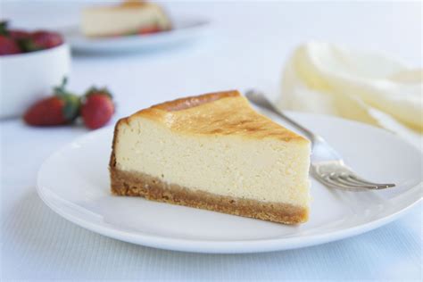 Photo of a baked cheesecake slice with golden-brown edges