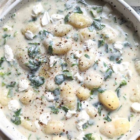 Thematic photo of gnocchi with spinach and gorgonzola sauce in a bowl