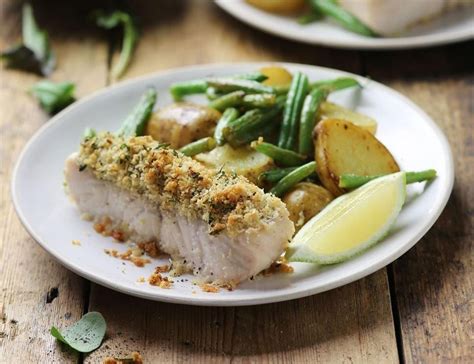 Thematic photo of hake fillet with parmesan crust, garnished with herbs